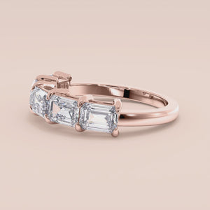 Elegant 14K rose gold wedding band featuring five emerald-cut diamonds, perfect for special occasions or everyday elegance. 