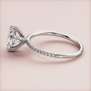 Elegant round solitaire engagement ring in white gold with pave accents, featuring a brilliant diamond and sparkling band options.