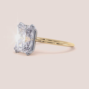 Video of Ava Minimalist Solitaire Radiant Cut Diamond Ring featuring a radiant cut diamond set in a two-tone band of either 14K/18K white and yellow gold or white and rose gold, designed for elegance and simplicity, ideal for engagements or special occasions. 