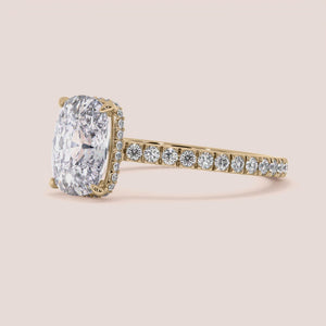 Elegant oval diamond engagement ring withPave-set band in yellow gold, available in 14K or 18K options.