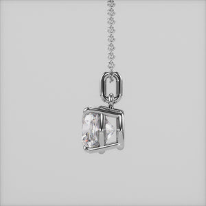 A detailed close-up of a cushion-cut solitaire diamond pendant set in a four-prong white gold basket. The refined craftsmanship highlights the brilliance of the diamond, making it a must-have piece for any fine jewelry collection.