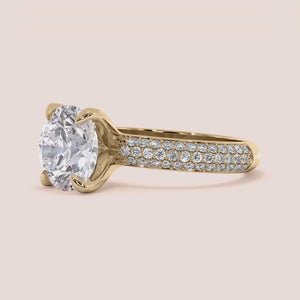 Elegant 14K or 18K gold pave solitaire engagement ring featuring a round diamond, showcasing timeless beauty. Not worn on model.