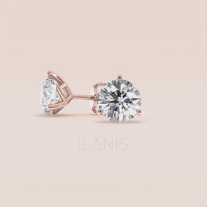 Timeless 3-Prong Martini Diamond Stud Earrings in 14kt/18kt rose gold on a soft pink background 
