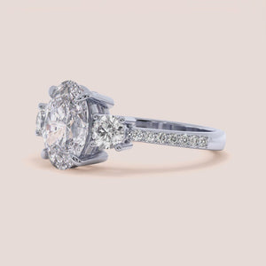 "Elegant 14K White Gold oval three-stone engagement ring with pave side stones, perfect for a timeless proposal.