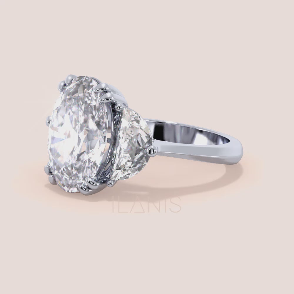 Close-up video of oval diamond three stone engagement ring in white gold with pear side diamonds, showcasing sparkle, prong setting details and fine craftsmanship in motion | #14KRecycledWhiteGold #18KRecycledWhiteGold #Platinum