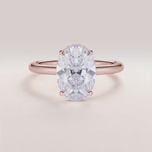 Elegant oval diamond engagement ring in rose gold, 14K and 18K options available, set in a polished band. Not worn on model.