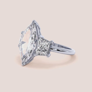 "Elegant 14K white gold marquise three-stone trapezoid engagement ring featuring exquisite jade accents. Perfect for special occasions.