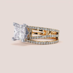 Two-tone 14K/18K gold engagement ring featuring a princess-cut diamond centerpiece and swirl pave band in yellow and white gold. 