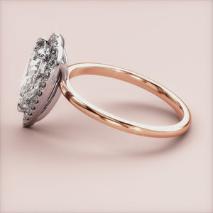 Elegant emerald-cut diamond engagement ring in 14K rose gold, worn on model, featuring a stunning pave band for a timeless look.