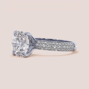 Elegant 14K, 18K, or platinum diamond solitaire engagement ring with round brilliant cut and pave band.