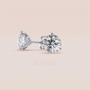 Timeless 3-Prong Martini Diamond Stud Earrings in white gold on a soft pink background 