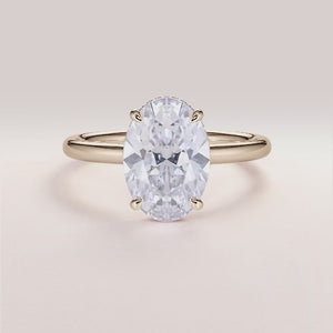Elegant oval-shaped diamond engagement ring in 14K or 18K gold or platinum with hidden halo, perfect for proposals.