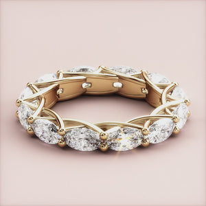 14K yellow gold eternity band ring featuring marquise-cut diamonds in an intricate lattice setting, not worn on model. 