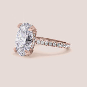 Rose gold teardrop halo engagement ring set featuring pear-shaped diamond, with options in 14K, 18K, or platinum settings.