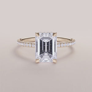 Elegant emerald-cut diamond engagement ring in rose gold, adorned with smaller diamonds. Available in 14K, 18K, and platinum.

#14KRecycledYellowGold
#18KRecycledYellowGold