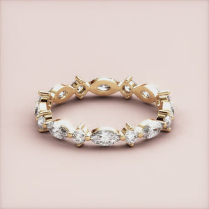 Elegant marquise and round diamond eternity band in 14K yellow gold, perfect for weddings.  Sophisticated design without model. 