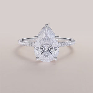 Elegant 14K white gold pear-shaped engagement ring withPave accents, showcasing a stunning diamond in an invisible gallery setting.