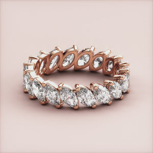 Elegant eternity band featuring marquise diamonds in 14K rose gold, perfect for weddings.  Not worn on a model. 