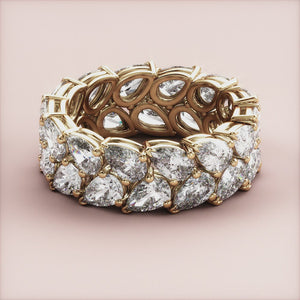 Elegant 14K or 18K gold wedding band featuring pear-shaped diamonds in a two-row eternity design, showcasing exquisite craftsmanship. 