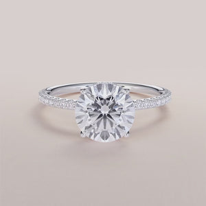 """Elegant 14K white gold Orion round wrapped hidden halo pave band engagement ring, perfect for timeless romance.""