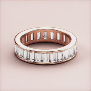 Elegant 14K or 18K rose gold wedding band featuring baguette-cut diamonds in channel setting for ultimate eternity style. 