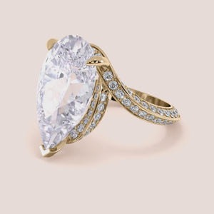 14K yellow gold Emery pear engagement ring with hidden halo accents and 3D pave prongs, perfect for timeless elegance.
