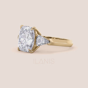 video of 14K yellow gold three stone cushion diamond engagement ring with shield side stones, perfect for timeless elegance. 