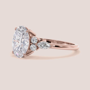 Elegant diamond engagement ring featuring a cushion-cut diamond and side stones, available in 14K, 18K gold, or platinum.
