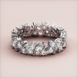 14K/18K/Platinum eternity band with marquise-cut and round diamonds, elegantly displayed on a neutral background. 