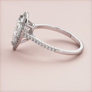 Exquisite pear-shaped diamond engagement ring in 14K/18K gold or platinum, featuring a halo setting and diamond-accented band.