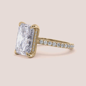 """14K yellow gold radiant hidden halo engagement ring with 3D pave details, perfect for the modern couple.""