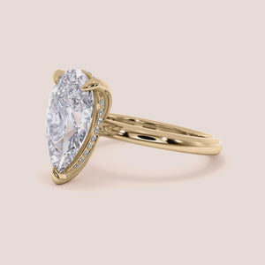 14K yellow gold pear hidden halo solitaire engagement ring with a sleek plain band, perfect for timeless elegance. 