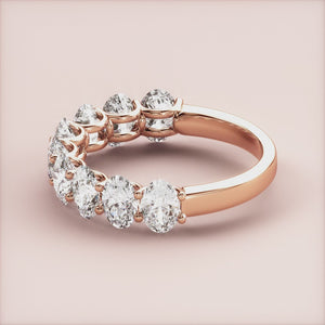 Elegant 14K or 18K rose gold wedding band featuring oval diamonds in a classic half eternity design. Perfect for everlasting love. 