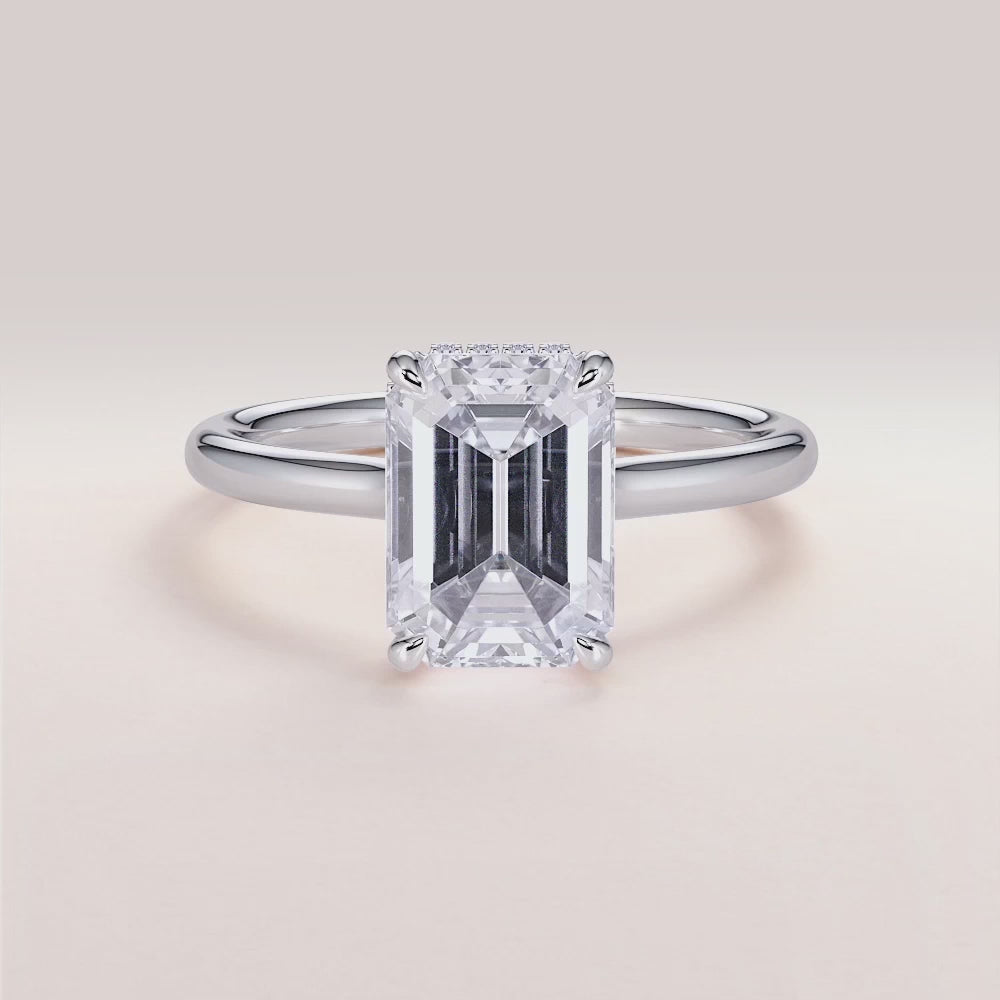Emerald cut diamond solitaire engagement ring in 14K or 18K gold or platinum with a hidden halo and plain band.
#14KRecycledWhiteGold
#18KRecycledWhiteGold
#Platinum