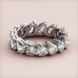 Elegant 14K or 18K gold wedding band featuring pear-shaped diamonds in a stunning eternity design, perfect for sophisticated styles. 