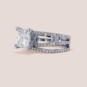 Elegant engagement ring with radiant-cut diamond in 14K or 18K gold or platinum, featuring a triple band and smaller diamonds.
