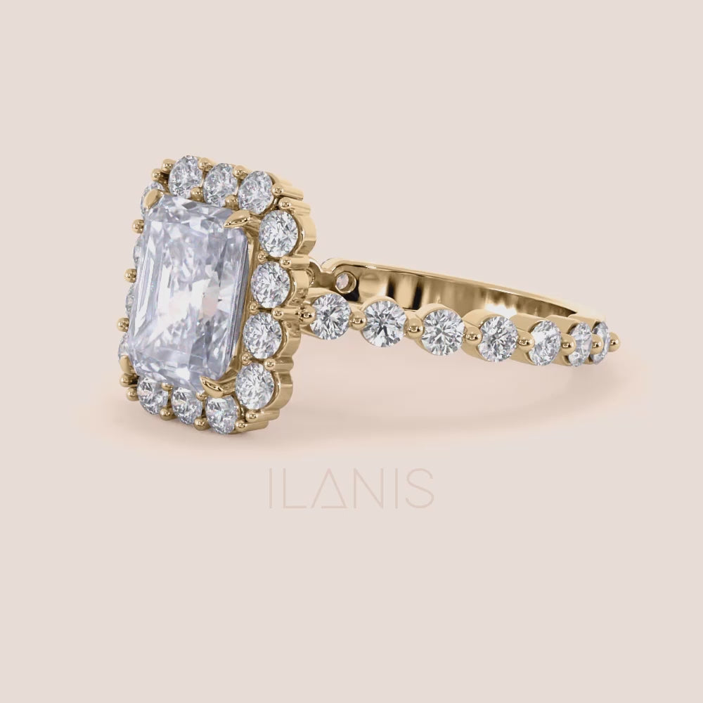 Close up video of radiant-cut diamond halo engagement ring showcasing sparkling diamond band in yellow gold | 

#14KRecycledYellowGold #18KRecycledYellowGold