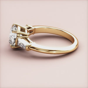 "Elegant 14K yellow gold engagement ring with round three-stone design and tapered baguettes, perfect for timeless romance.
