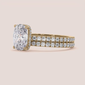 Elegant 14K yellow gold engagement ring set with oval diamond andPave detailing, showcased on model's finger.