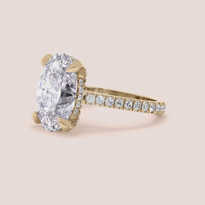 Radiant-cut diamond engagement ring with side stone accents in 14K yellow gold, displayed on a neutral background.