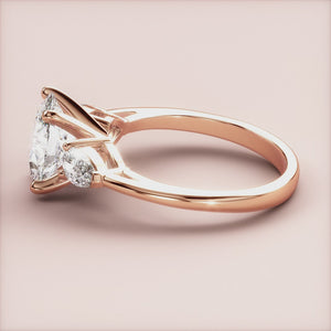 "Rose gold 14K engagement ring featuring an oval three-stone pear design, perfect for timeless elegance and romance.
