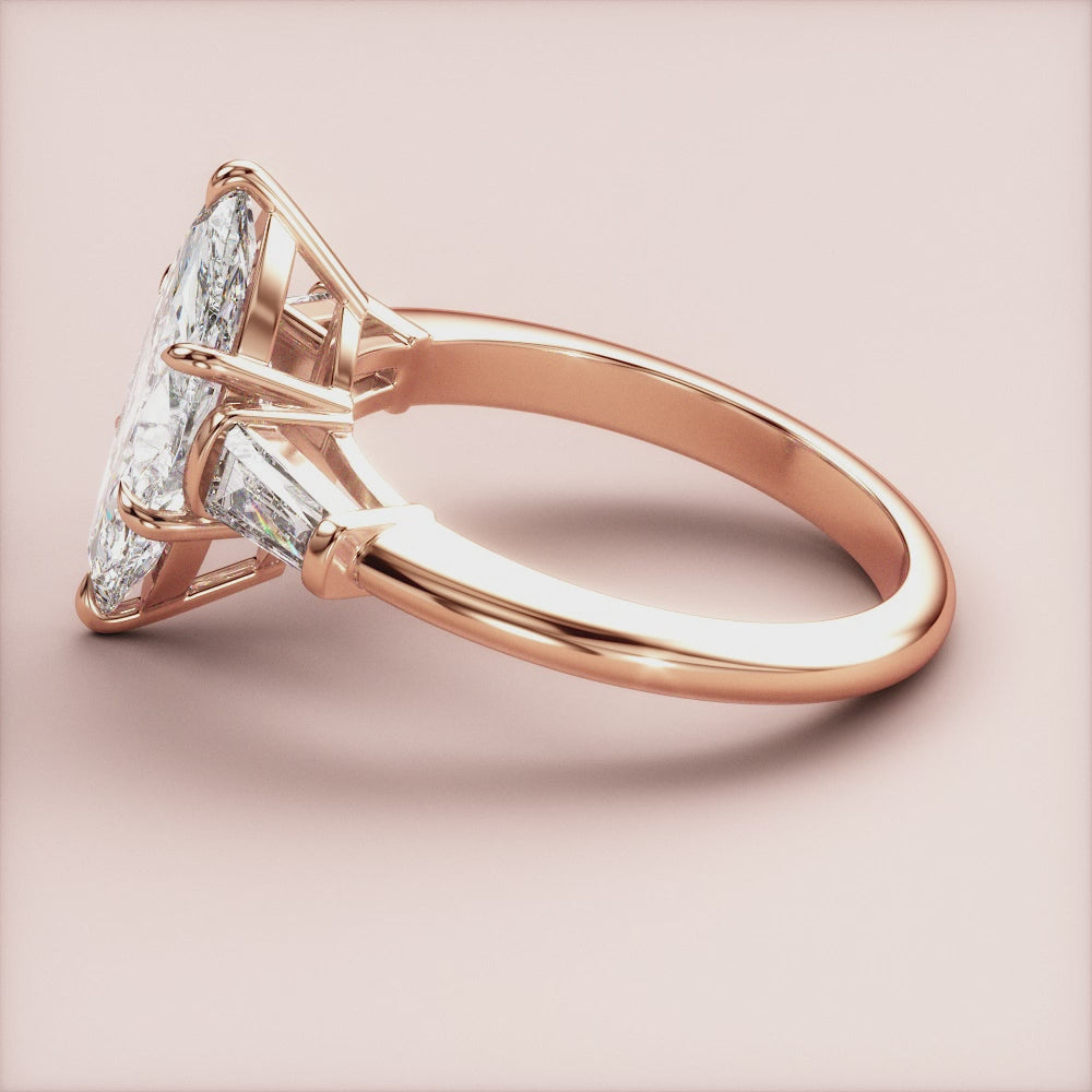 "Elegant 14K rose gold marquise three-stone tapered baguette engagement ring, perfect for timeless romance and sophistication.|







#14KRecycledRoseGold
#18KRecycledRoseGold


"
