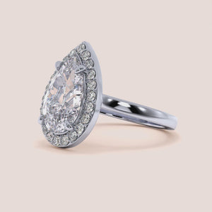 Exquisite pear-shaped diamond engagement ring with halo setting in 14K white gold, showcasing dazzling brilliance.