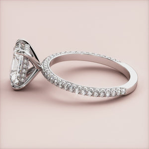 Elegant 14K white gold engagement ring with dazzling oval-cut diamond and pave-set band, side view on a plain background.