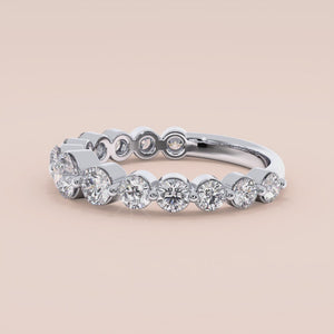 Elegant round diamond eternity wedding band in 14K or 18K white gold, featuring a stunning row of sparkling round-cut diamonds. 