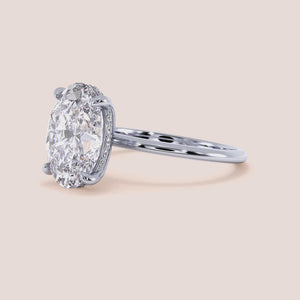 "Elegant oval-cut diamond engagement ring in 14K or 18K gold or platinum, showcasing timeless beauty on a neutral background."

