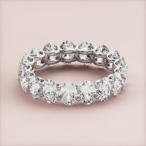 Elegant 14K or 18K gold eternity band with round-cut diamonds, perfect for weddings and special occasions. 
