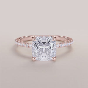 Elegant cushion-cut diamond engagement ring in 14K rose gold, featuring a pave band with dazzling diamonds.