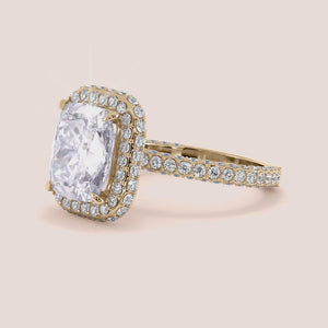 Radiant-cut diamond engagement ring with side stone accents in 14K yellow gold, displayed on a neutral background.