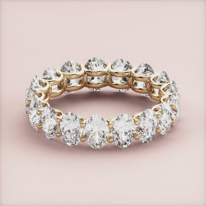 Elegant 14K yellow gold eternity wedding band with round brilliant cut diamonds, offering a luxurious and timeless design. 